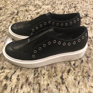 Black grommeted sneakers